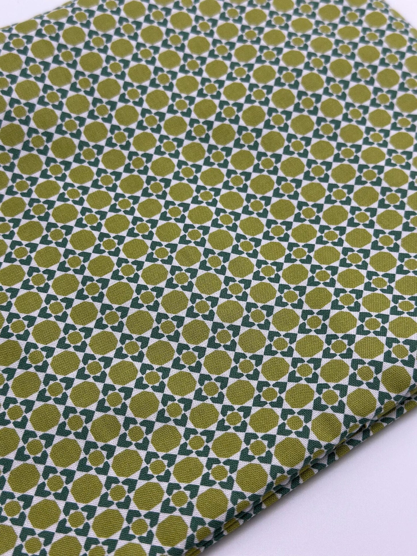 Olive green geometric print cotton fabric close-up for handmade heating pad