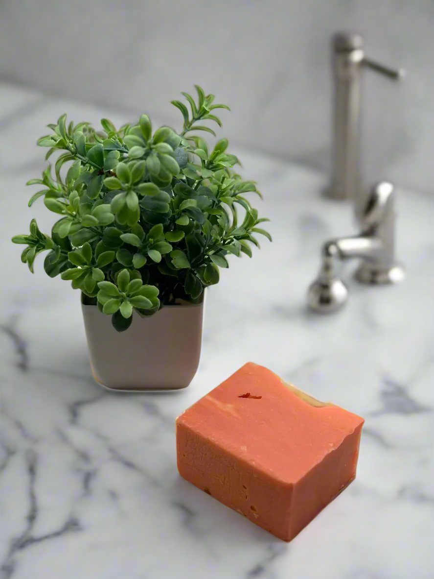 handmade amber soap amber color with a green decoration on the side.