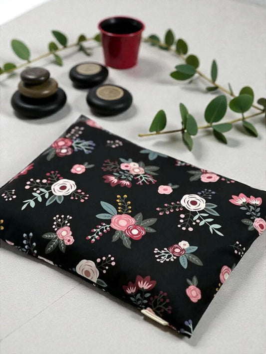 Floral-patterned notebook on a white surface with decorative elements